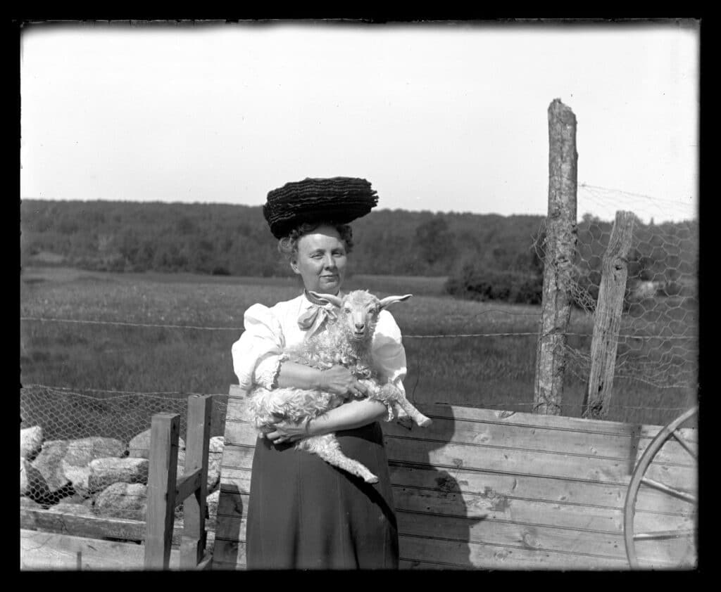Woman from the mid-19th century holding a baby sheep 